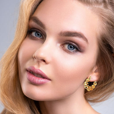 Gold Earrings on woman