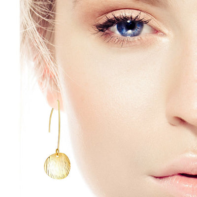 Gold earrings on woman