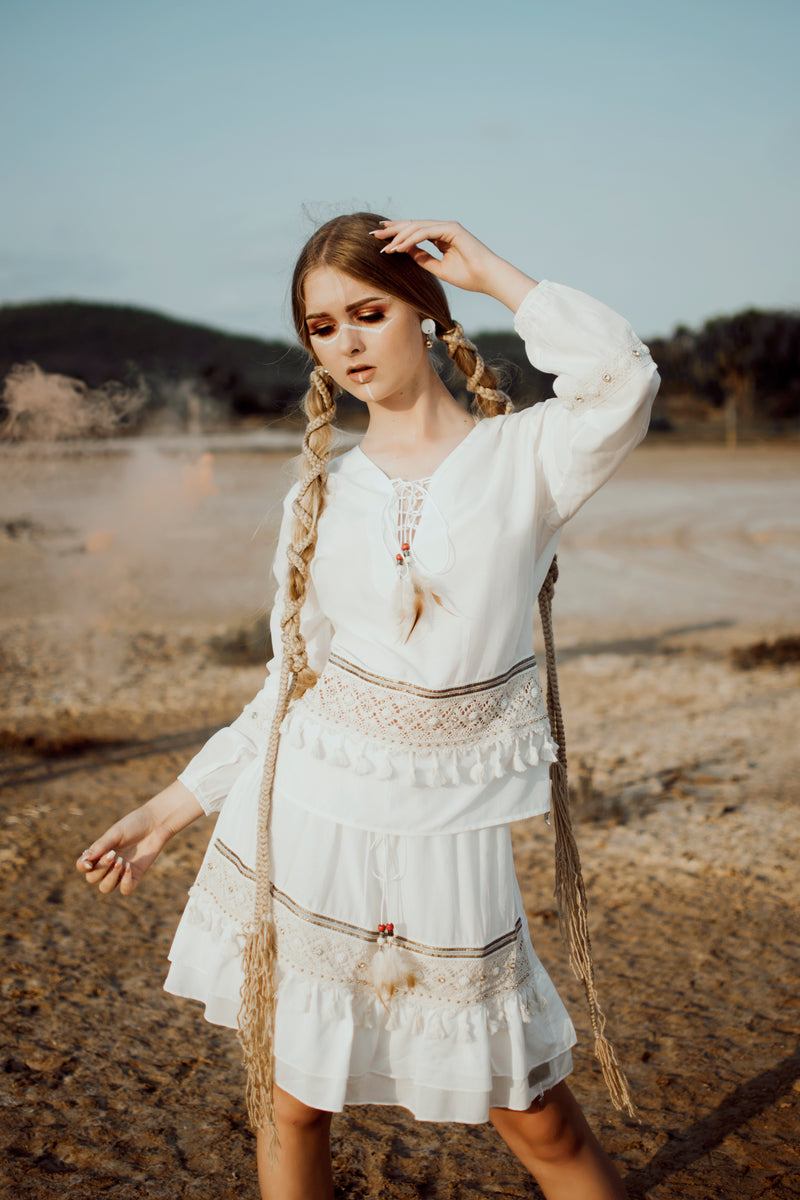 bohemian girl with braids and tassel top